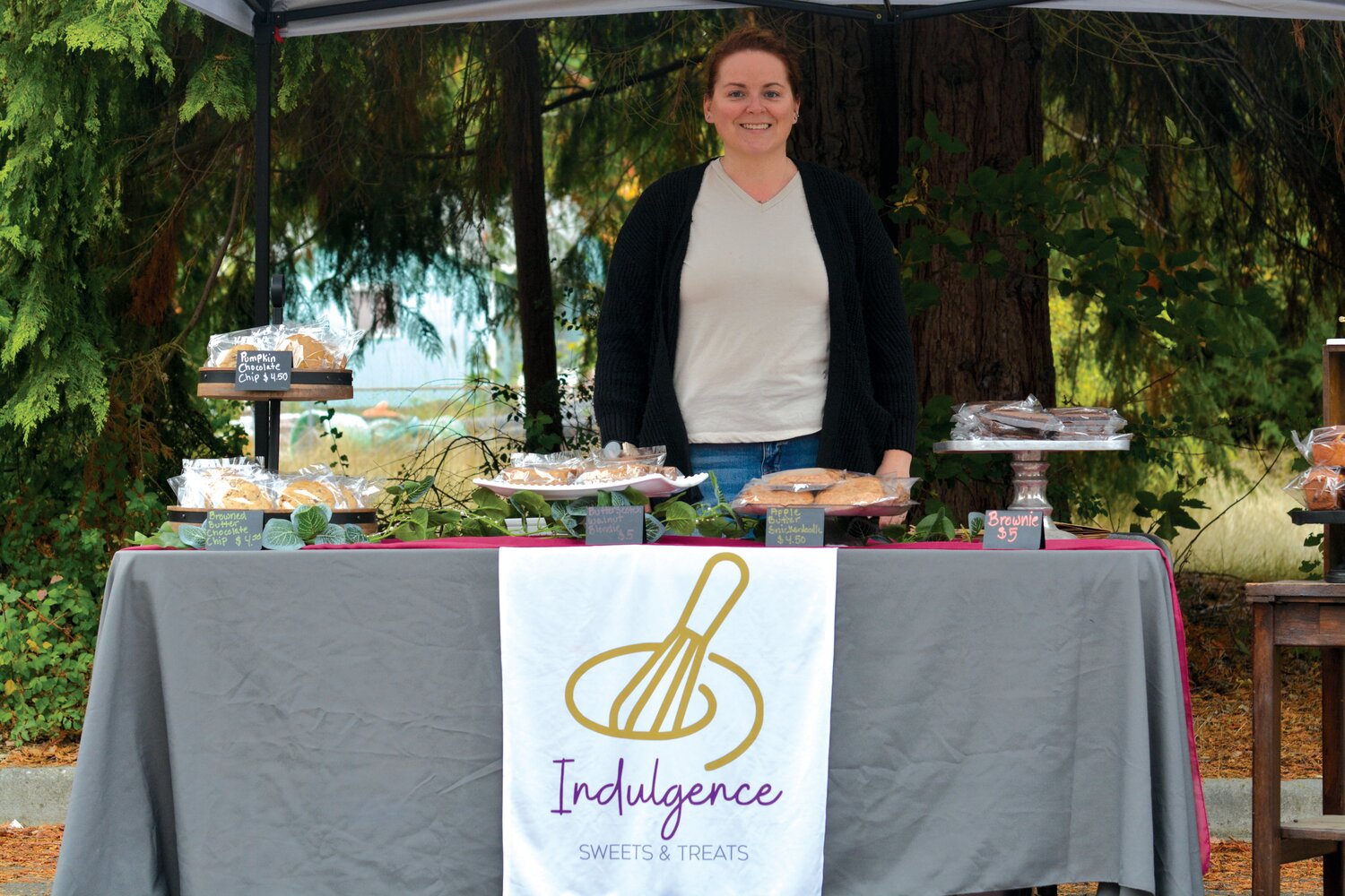 Andrea Saffer, with Indulgence Sweets and Treats, smiles at the final Yelm Farmers Market of the year.