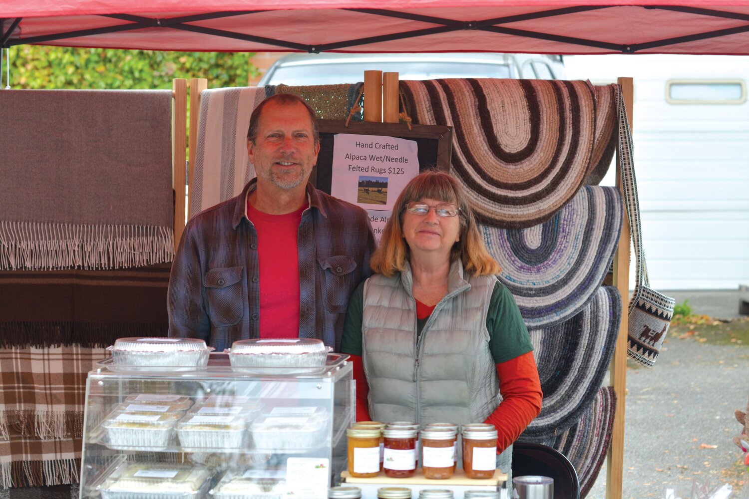 Steve and Tammy Owens smile for a picture on Sept. 30 at the final Yelm Farmers Market of the year.