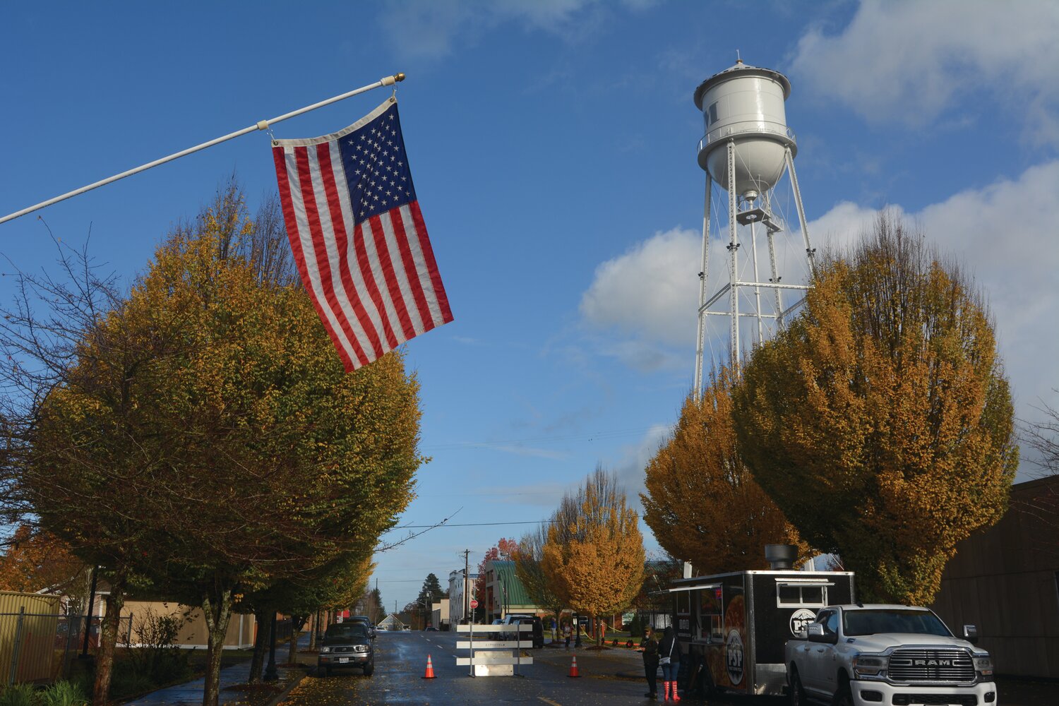 The American Flag and Yelm water tower are in view as attendees of the Yelm Veterans Day concert order pizza from Puget Sound Pizza on Nov. 11.