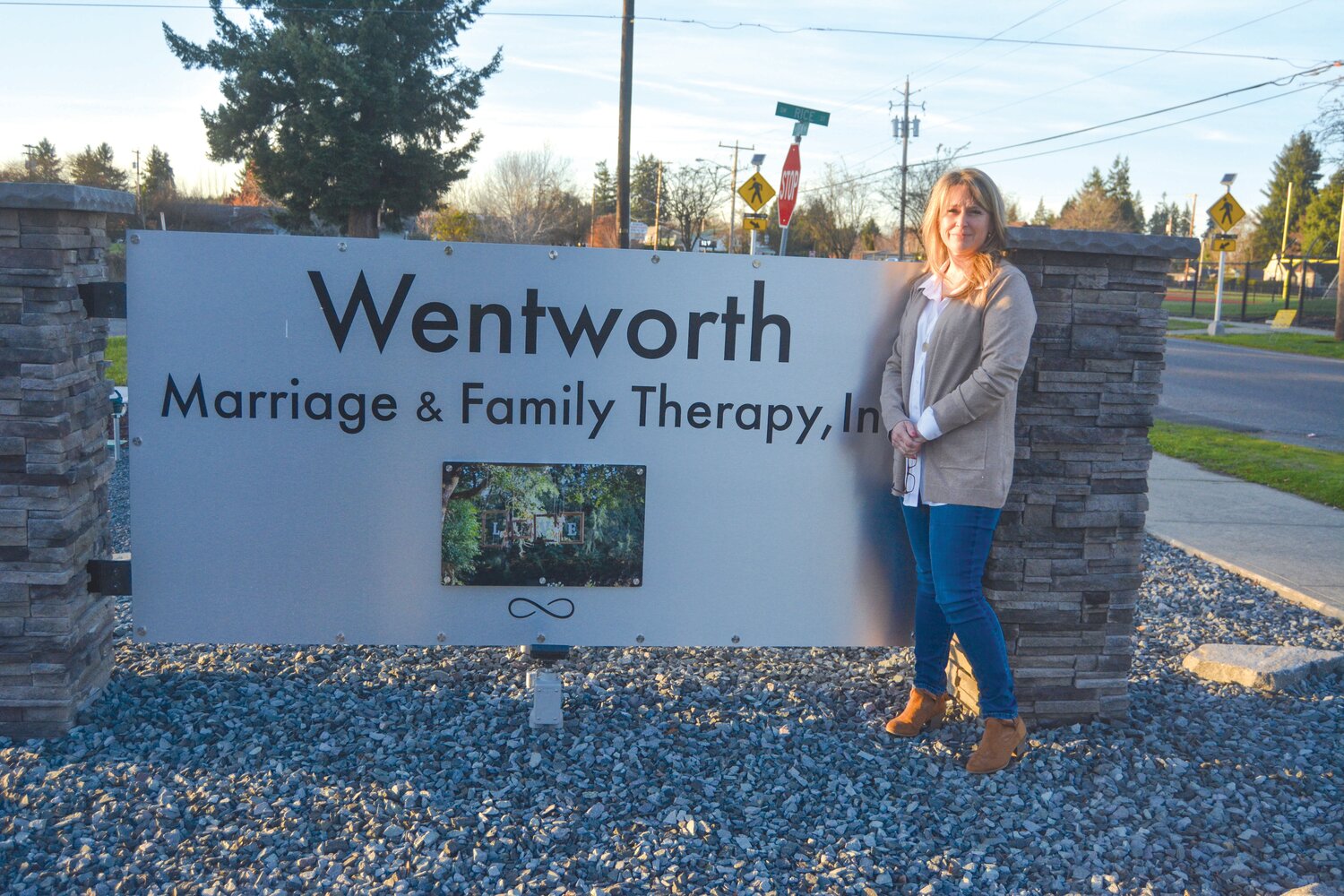 Jennifer Wentworth stands with her sign in front of her business, located at 313 W. Yelm Ave., on Nov. 16.