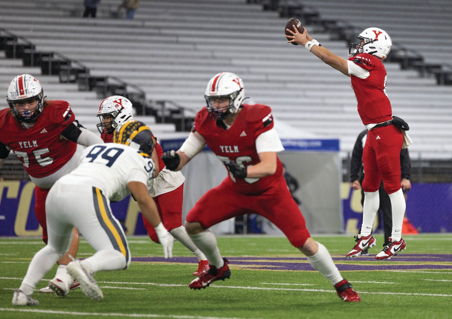 Yelm quarterback Damian Aalona leaps for the football during the 3A state championship game at Husky Stadium on Friday, Dec. 1.