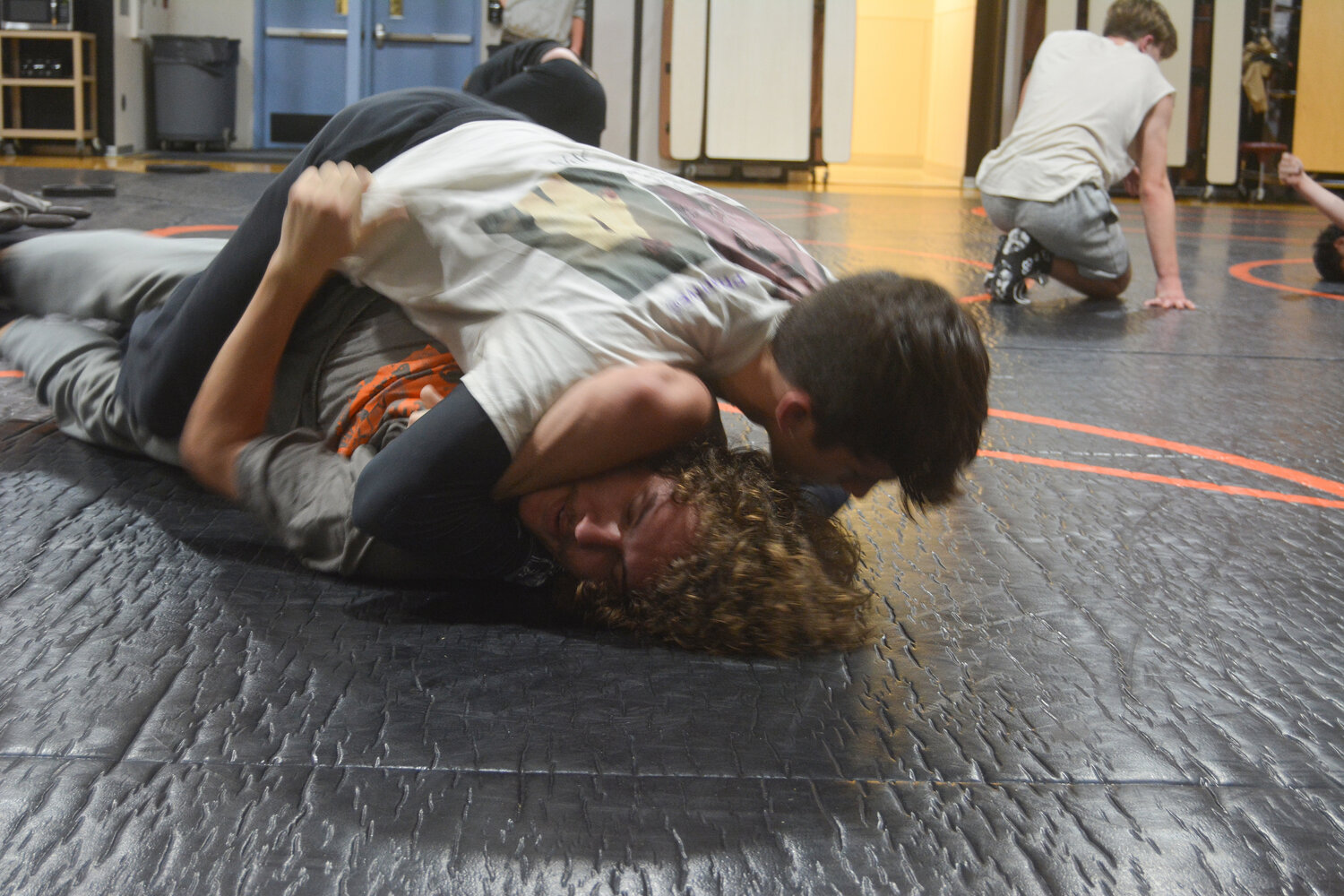 Zander Peck pins down Connor Power during practice on Nov. 30.
