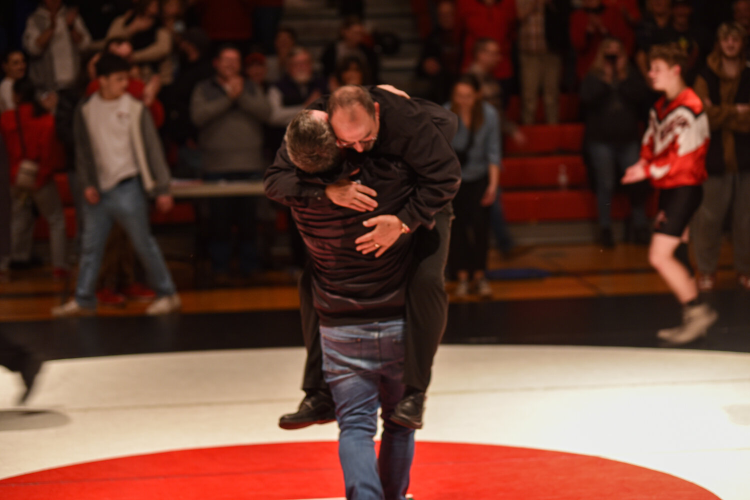 Yelm's head coach Gaylord Strand celebrates with Bethel's head coach Matt Lininger after the "Bad to the Bone" dual on Jan. 23 between the Tornados and the Bison.