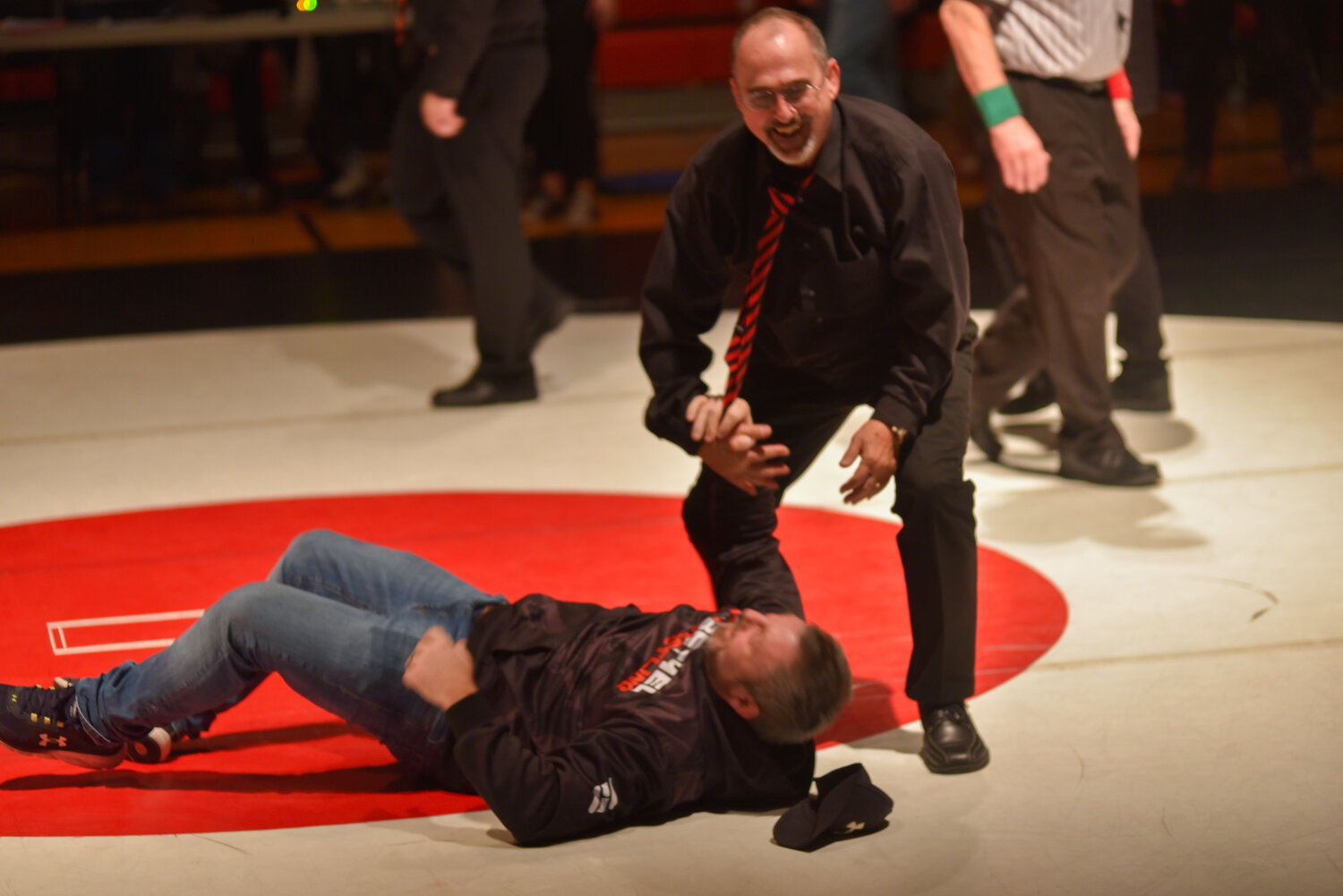 Yelm's head coach Gaylord Strand celebrates tossing Bethel's head coach Matt Lininger after the "Bad to the Bone" dual on Jan. 23 between the Tornados and the Bison.