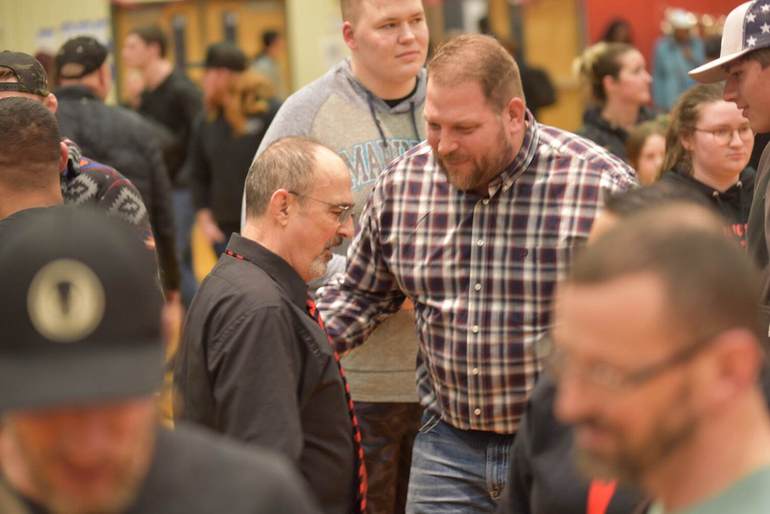 Yelm's head wrestling coach Gaylord Strand embraces a person who attended his final home dual as a Tornado after the "Bad to the Bone" dual against Bethel.
