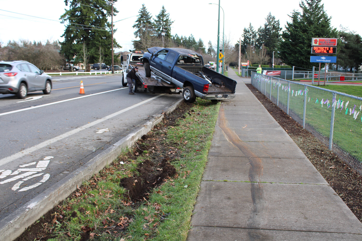 A Dodge Ram truck leaves a trail on the sidewalk after crashing in front of Yelm High School on Jan. 30.