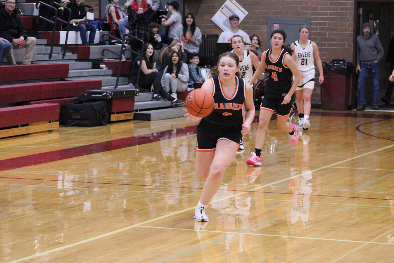 Brooklynn Swenson races down the floor before laying in a buzzer-beating shot to close the first half against Raymond-South Bend on Feb. 6.