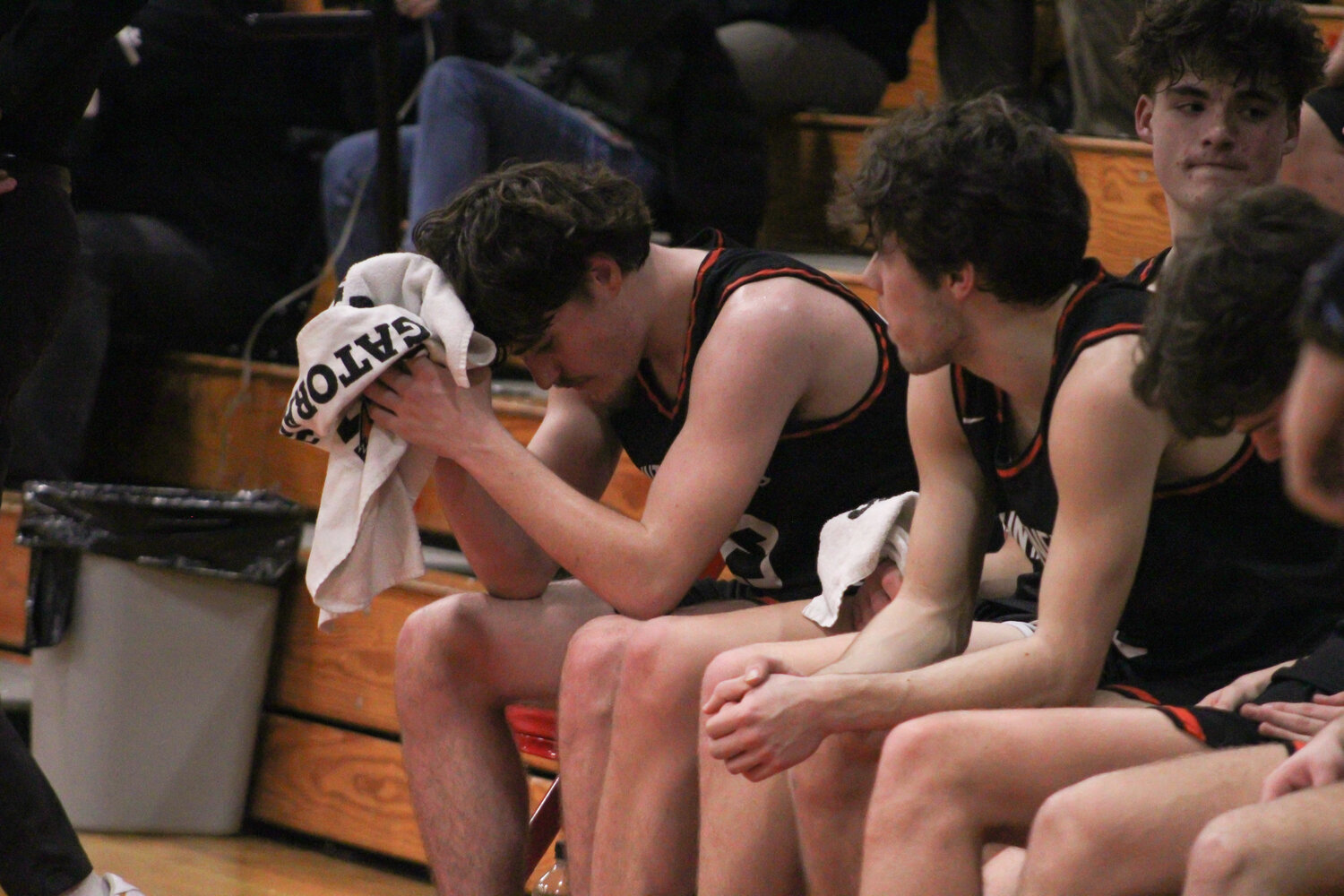 Jared Sprouffske sits on the bench in disappointment as Ilwaco defeated Rainier, 74-56, on Feb. 9.